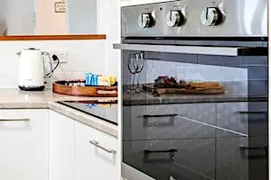 Kitchen with oven, stove, dishwasher, fridge and all pantry essentials